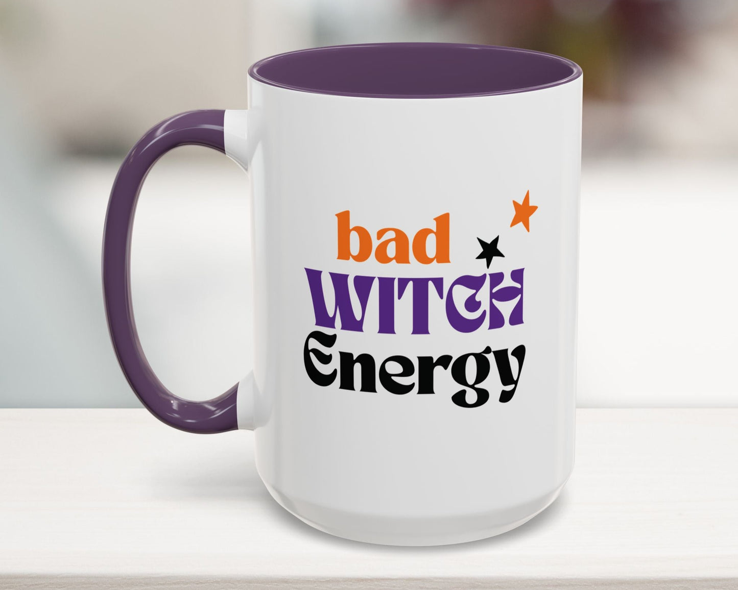 White mug with purple handle and interior, featuring 'bad witch energy' text.