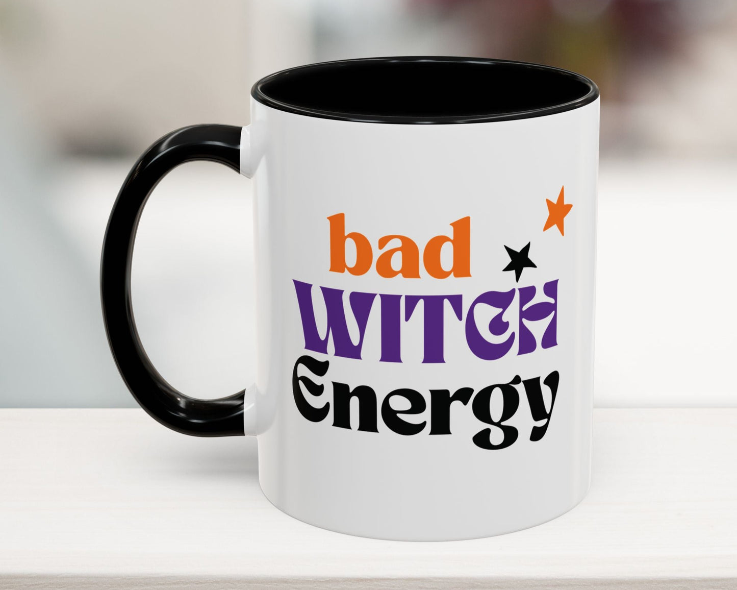 Mug with 'bad witch energy' text on a white surface