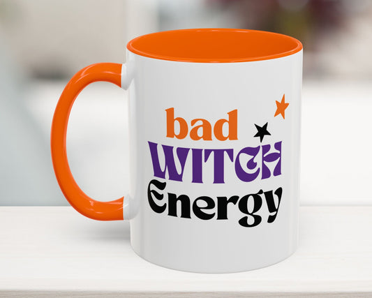 Mug with 'bad witch energy' text on a white surface