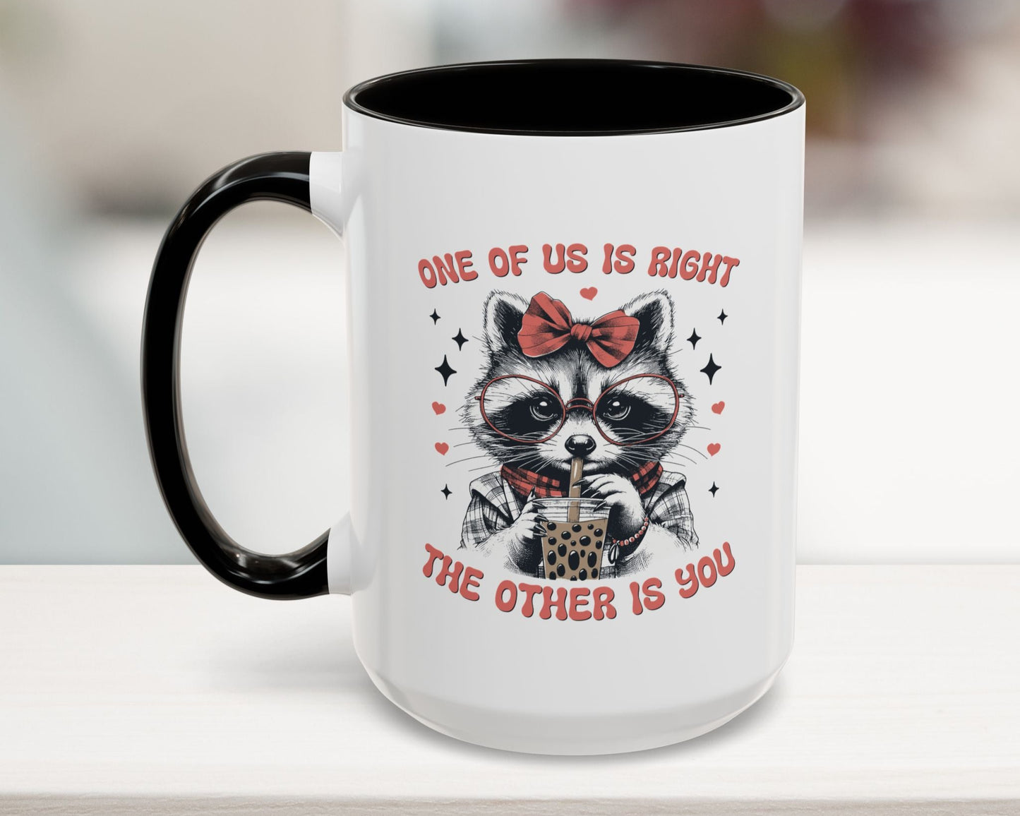 Mug with a raccoon design and text on a white surface