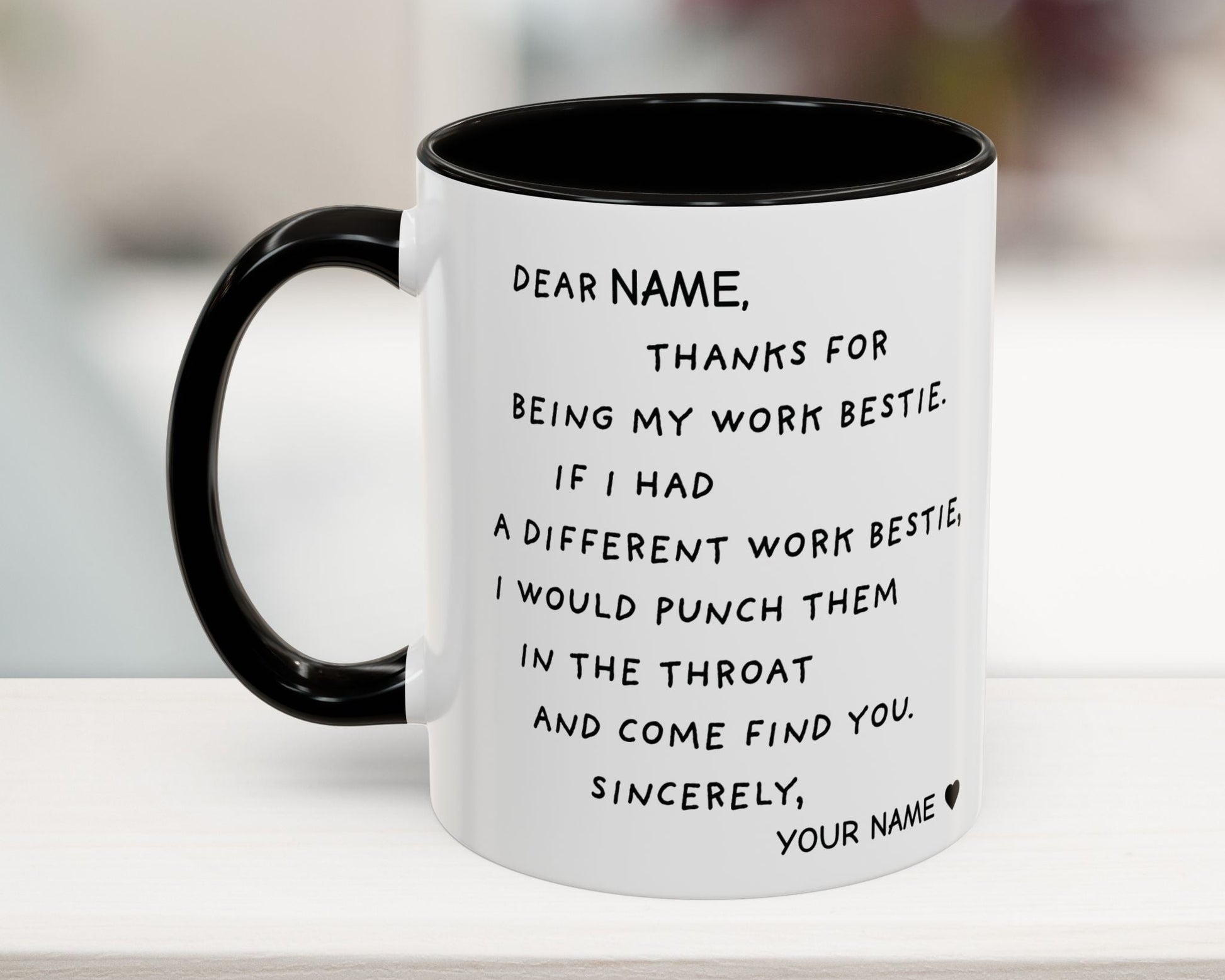 White mug with black interior and handle, featuring a humorous message on a blurred background.