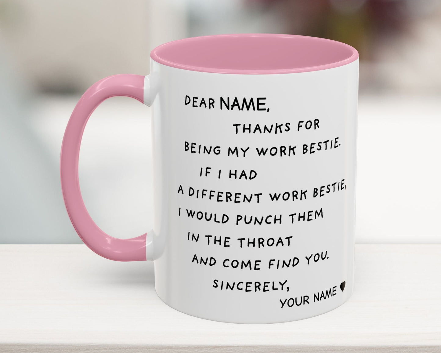 White mug with pink handle and humorous text message on a blurred background