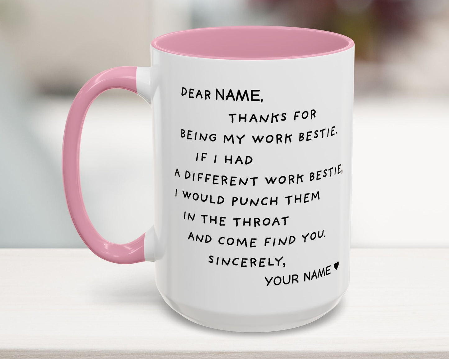 Mug with pink interior and handle featuring humorous text on a blurred background