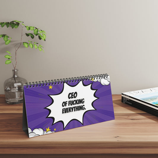 Desk calendar with a humorous quote on a wooden surface