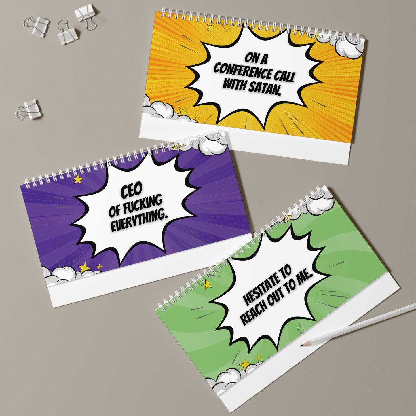 pages with colorful comic-style text on a gray surface.