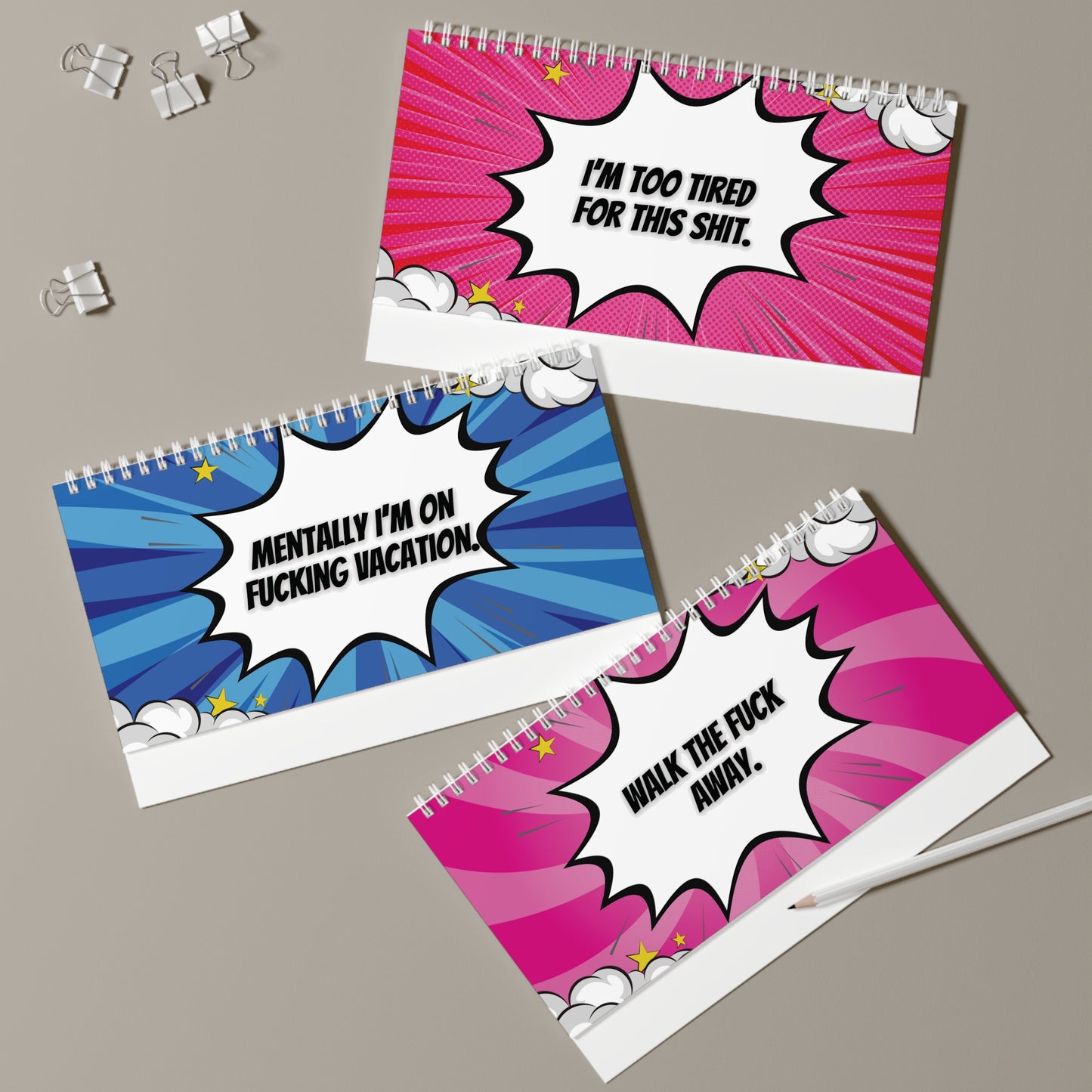 pages with colorful comic-style text on a gray surface.