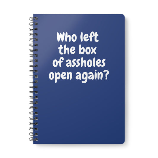 dark blue notebook with sarcastic “Who left the box of assholes open again?” quote