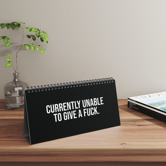 Office humor desk sign showing “I’M ON MUTE FOR A REASON” in a work-from-home setup