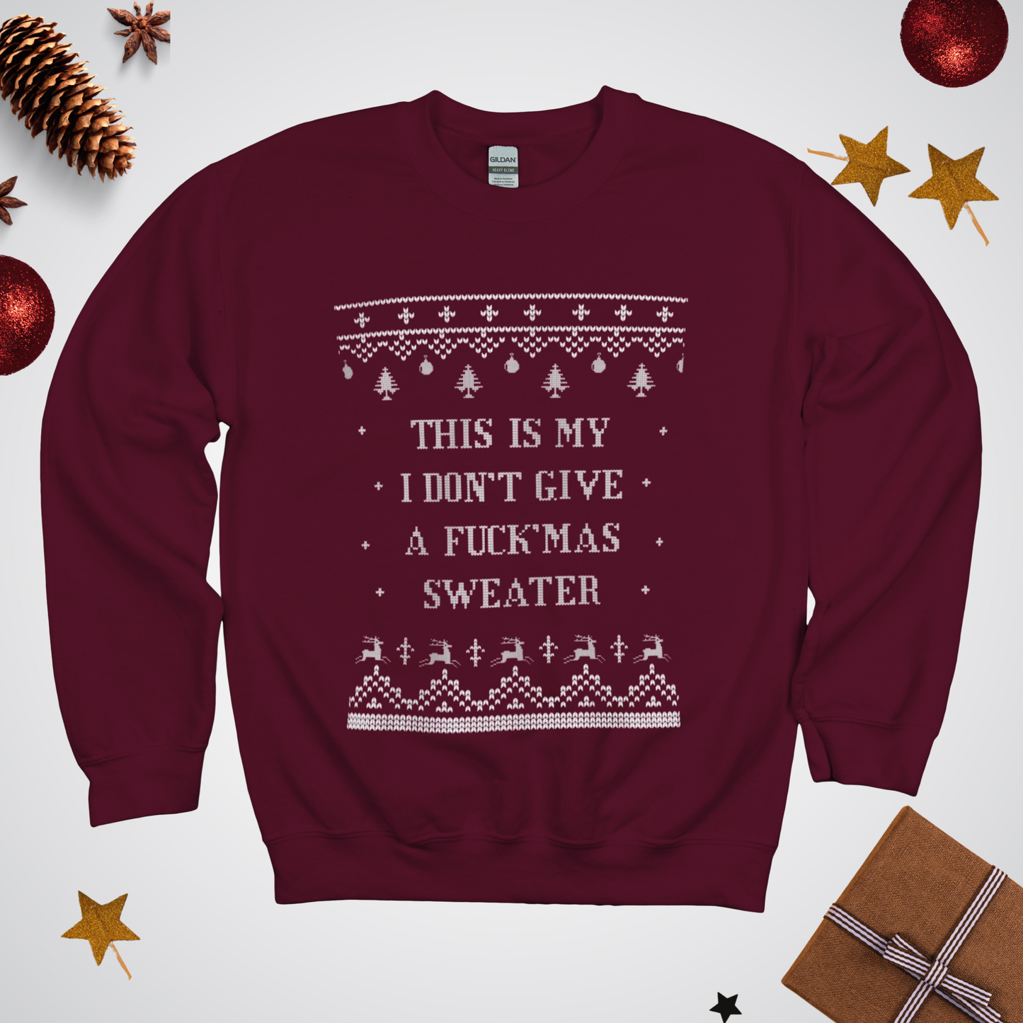 Maroon sweater with Christmas-themed text and patterns on a white background with festive decorations.