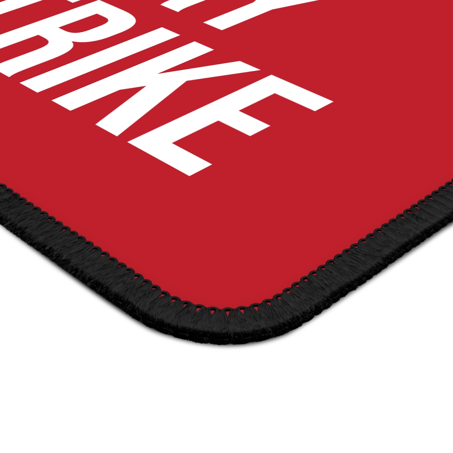 Close-up of dark red neoprene mouse pad with stitched edges