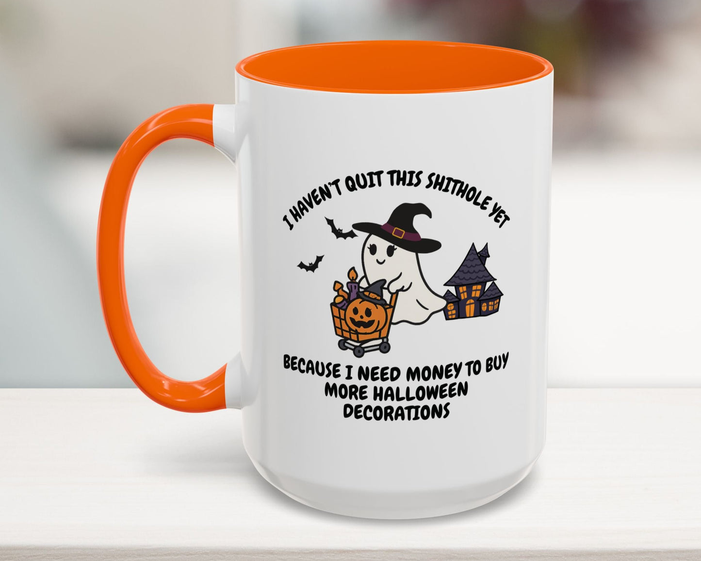 Halloween-themed mug with ghost and pumpkin design on a blurred background
