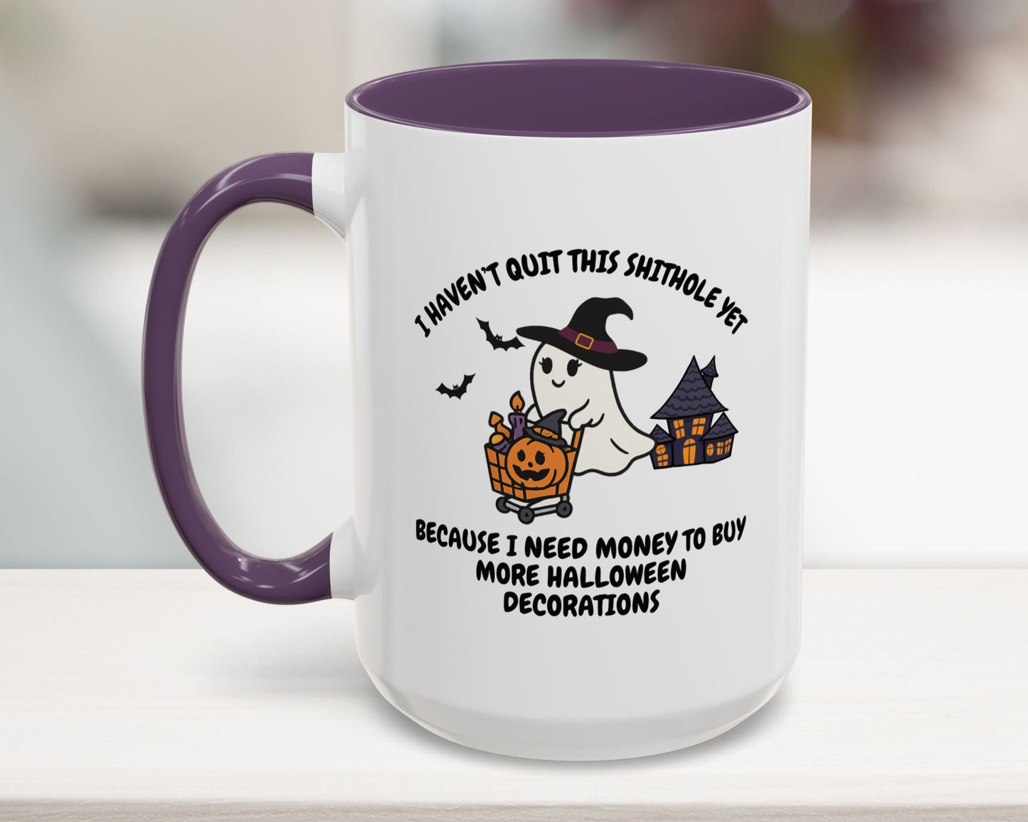 Halloween-themed mug with ghost and pumpkin design on a white surface