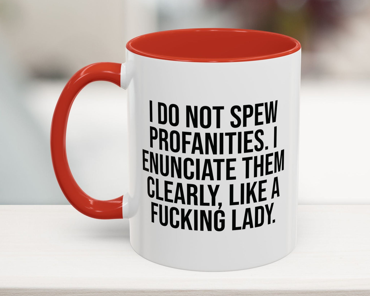 Red 11oz coffee mug with a humorous profanity quote: 'I do not spew profanities, I enunciate them clearly, like a fucking lady.' Ideal gift for women.