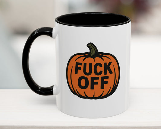 Mug with a pumpkin design and text on a white surface