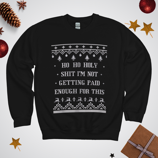 Black sweater with Christmas-themed text and graphics on a white background with festive decorations.