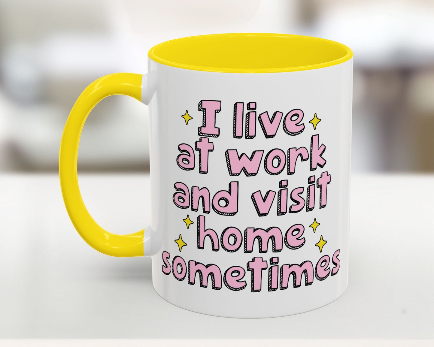 Mug with yellow interior and handle, featuring pink text on a blurred background