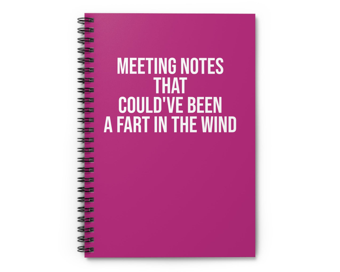 Pink notebook with humorous text on a white background
