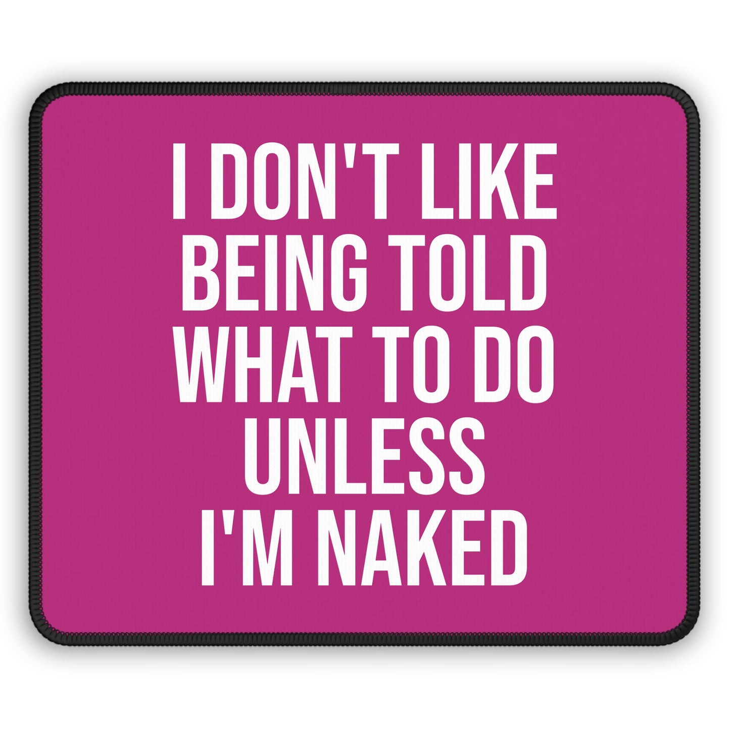Pink mouse pad with “I Don’t Like Being Told What To Do Unless I’m Naked” quote