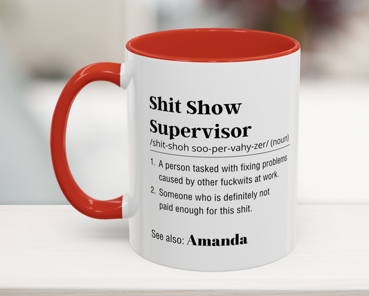 Mug with red interior and handle featuring humorous definition text on a blurred background