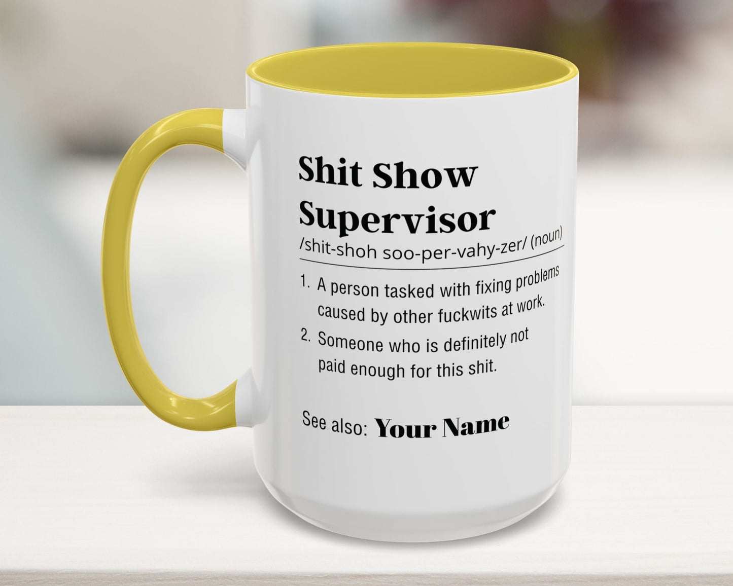 Mug with yellow interior and handle on a blurred background