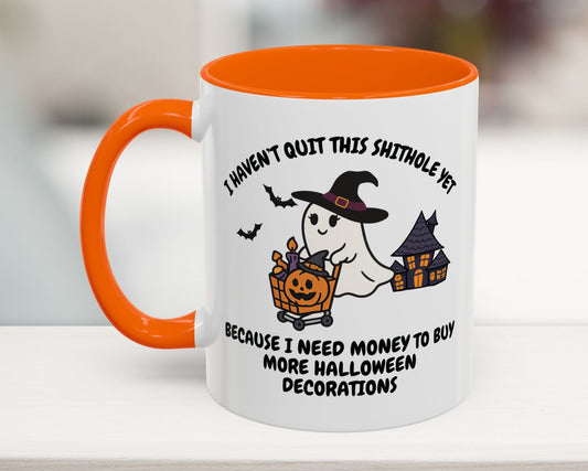Halloween-themed mug with ghost and pumpkin design on a blurred background