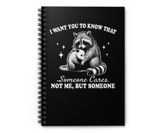 Notebook cover featuring raccoon hugging possum and quote: ‘Someone Cares Not me, But someone'