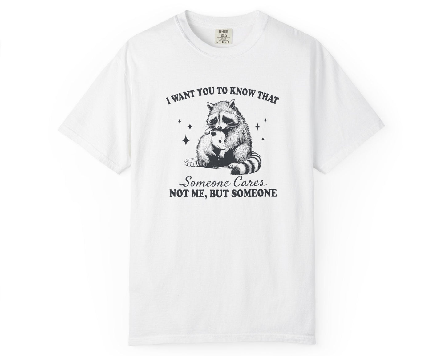 White unisex T-shirt with raccoon hugging possum and text: ‘Someone Cares (Not Me)’