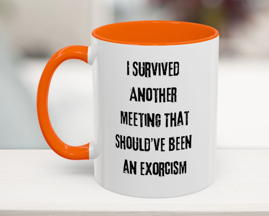 White mug with orange handle and interior, featuring humorous text on a blurred background