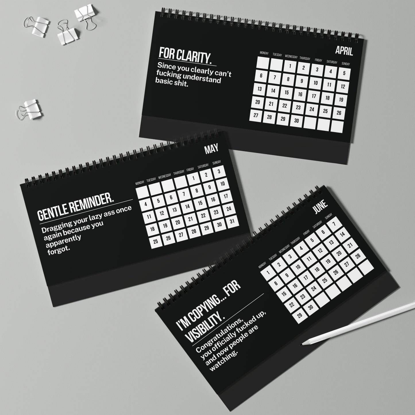 Three black calendars with humorous text on a gray background