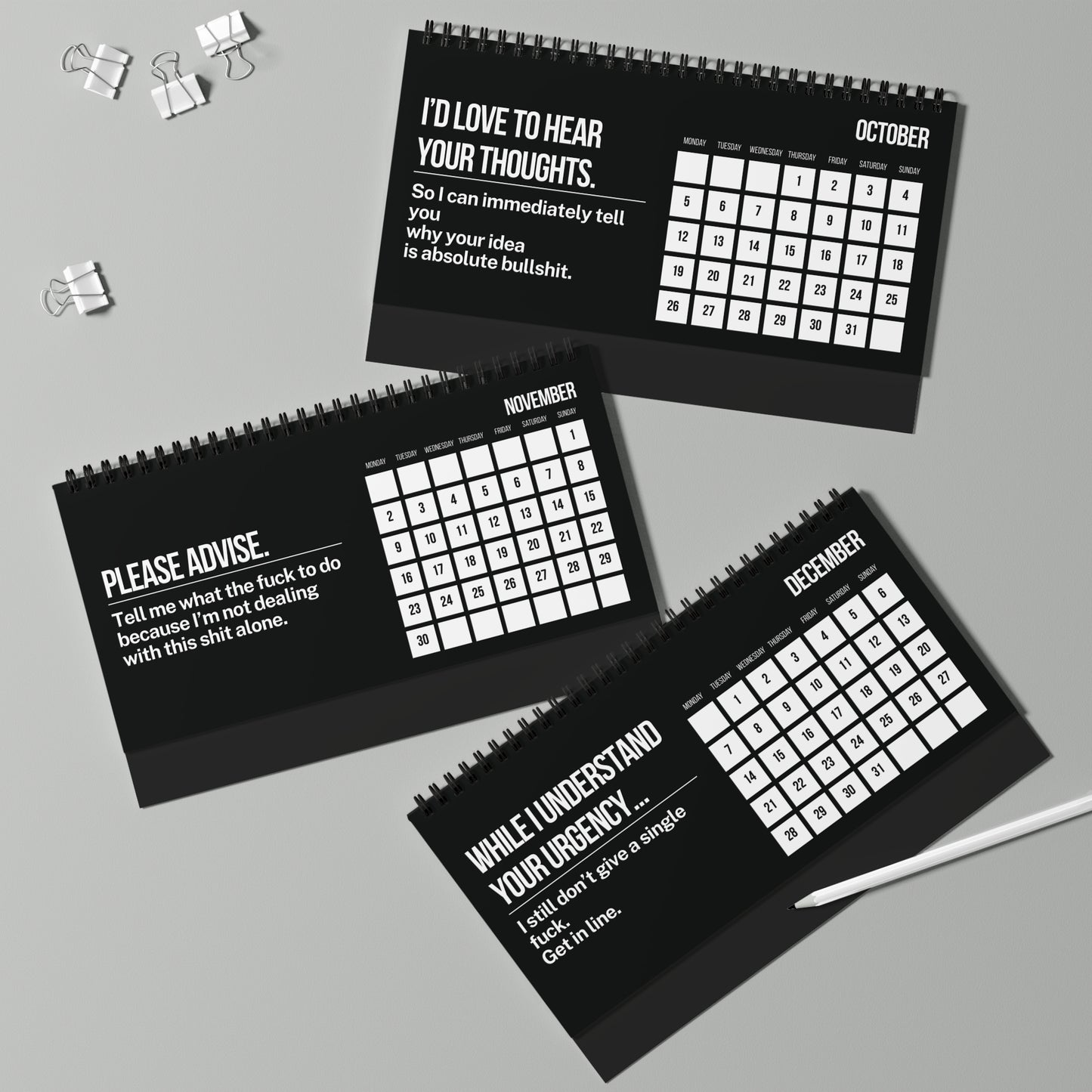 Three black calendars with humorous text on a gray background