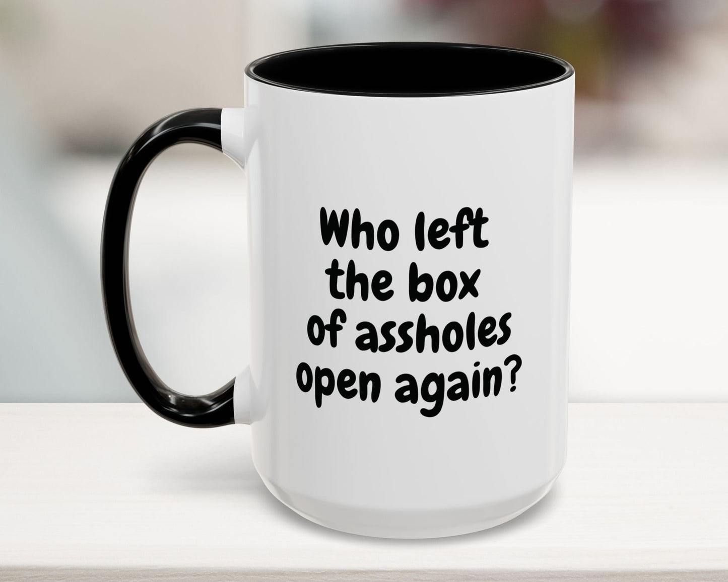 Black 15oz mug with “Who left the box of assholes open again?” quote