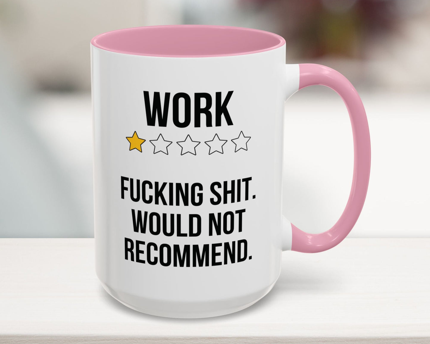 Mug with pink interior and handle featuring text and star ratings.