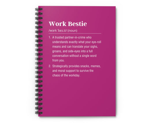 Pink notebook with text definition on a white background