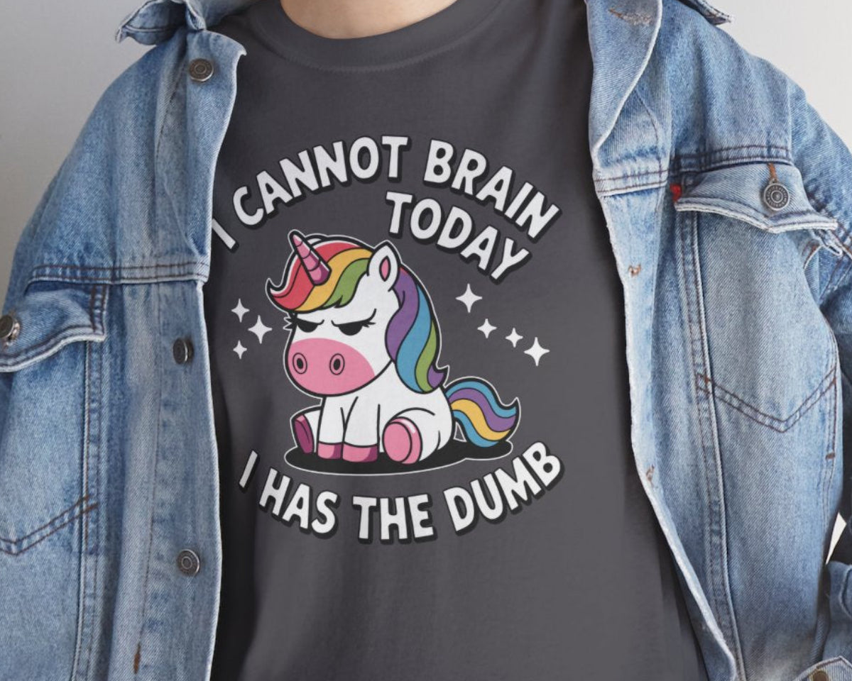 Person wearing a dark gray t-shirt with a unicorn graphic and text, paired with a denim jacket.