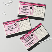 Three spiral-bound desk calendar pages for January, February, and March are arranged on a light gray background with binder clips and a white stylus. The pages have pink and black headers, a monthly calendar grid, and bold profane text in the message boxes.