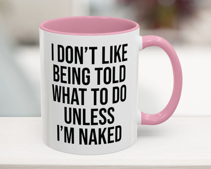 White mug with pink handle and interior, featuring a humorous quote.
