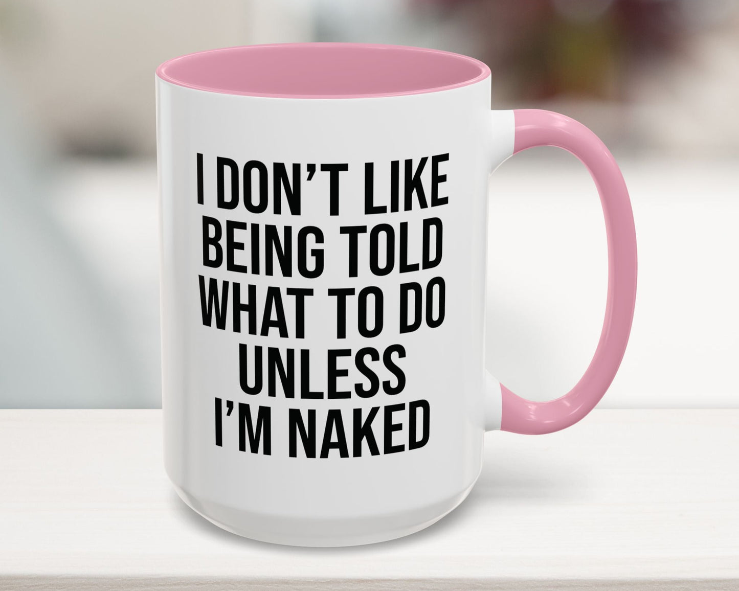 White mug with pink interior and handle, featuring a humorous quote.