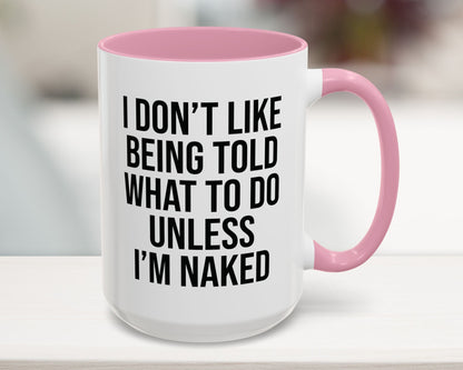 White mug with pink interior and handle, featuring a humorous quote.
