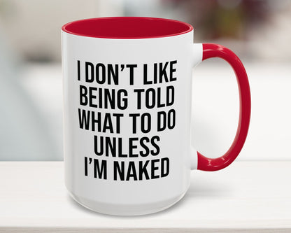 White mug with red interior and handle, featuring a humorous quote.