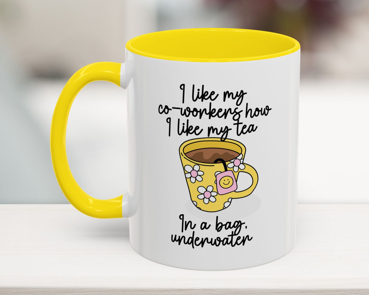 White mug with yellow handle and interior, featuring a cartoon cup and humorous text.