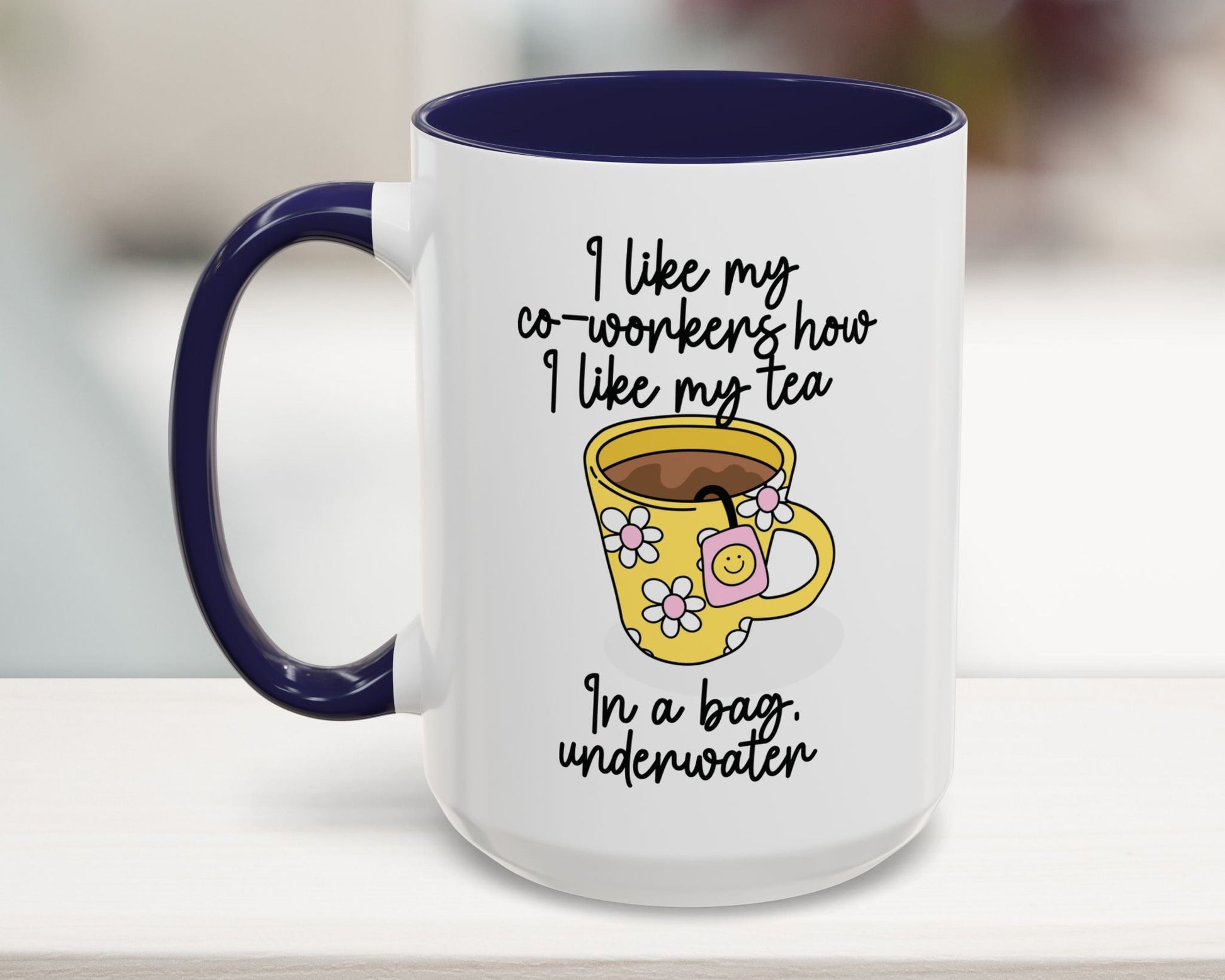 White mug with blue interior and handle, featuring a yellow cartoon cup and humorous text.