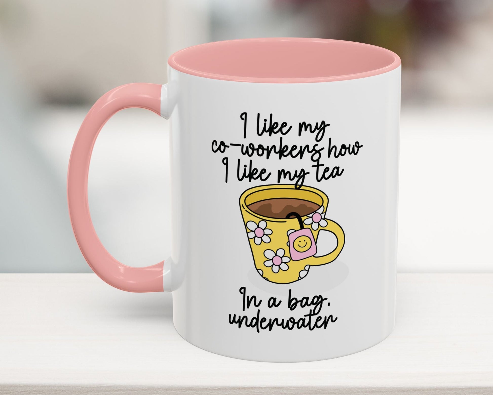 White mug with pink interior and handle, featuring a yellow cartoon cup and humorous text.