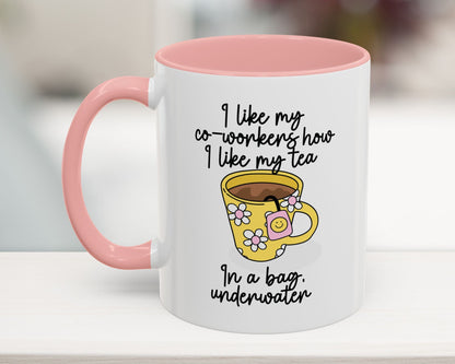 White mug with pink interior and handle, featuring a yellow cartoon cup and humorous text.