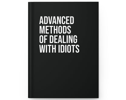 Black book with white text 'Advanced Methods of Dealing with Idiots' on a white background