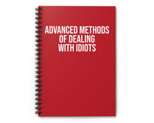 Red notebook with white text on a white background