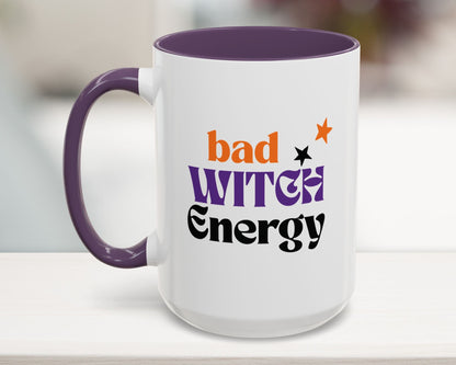 White mug with purple handle and interior, featuring 'bad witch energy' text.