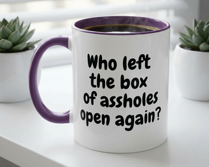 White mug with purple interior and handle, featuring text, on a surface with plants in the background.