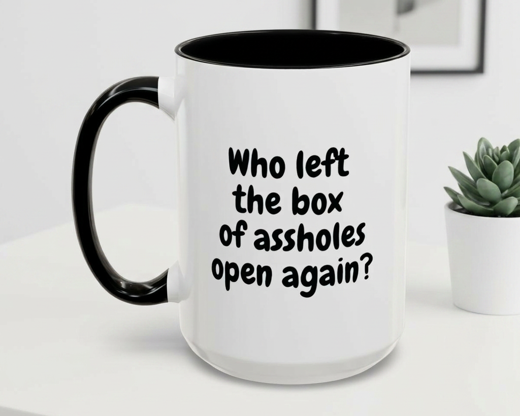 White mug with black interior and handle, featuring text on a white surface.