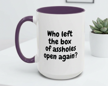 White mug with purple handle and interior, featuring text on a white surface with a plant in the background