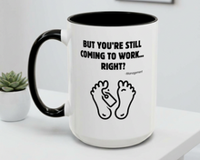 White mug with black interior and handle, featuring text and footprints on a white surface.